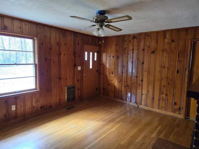 a view of an empty room with wooden floor