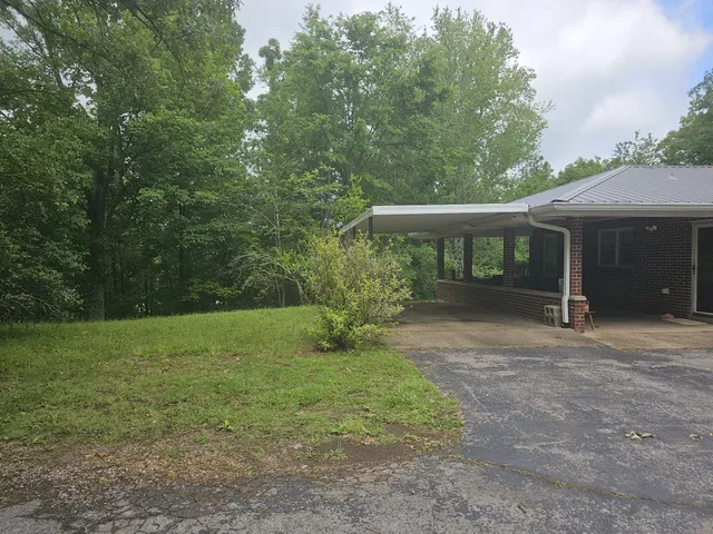 a kitchen with granite countertop a refrigerator stove and sink