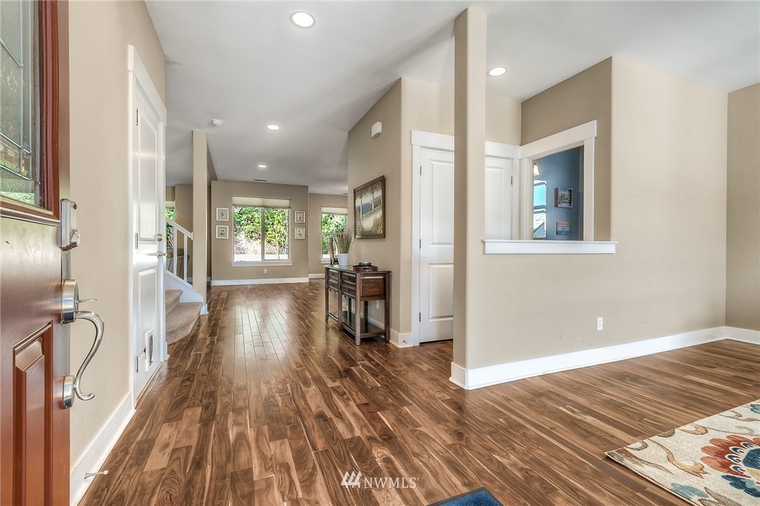 5236 Northeast 9th Place Renton, WA 98059 - Photo 3 of 27 a view of a hallway with wooden floor and a living room