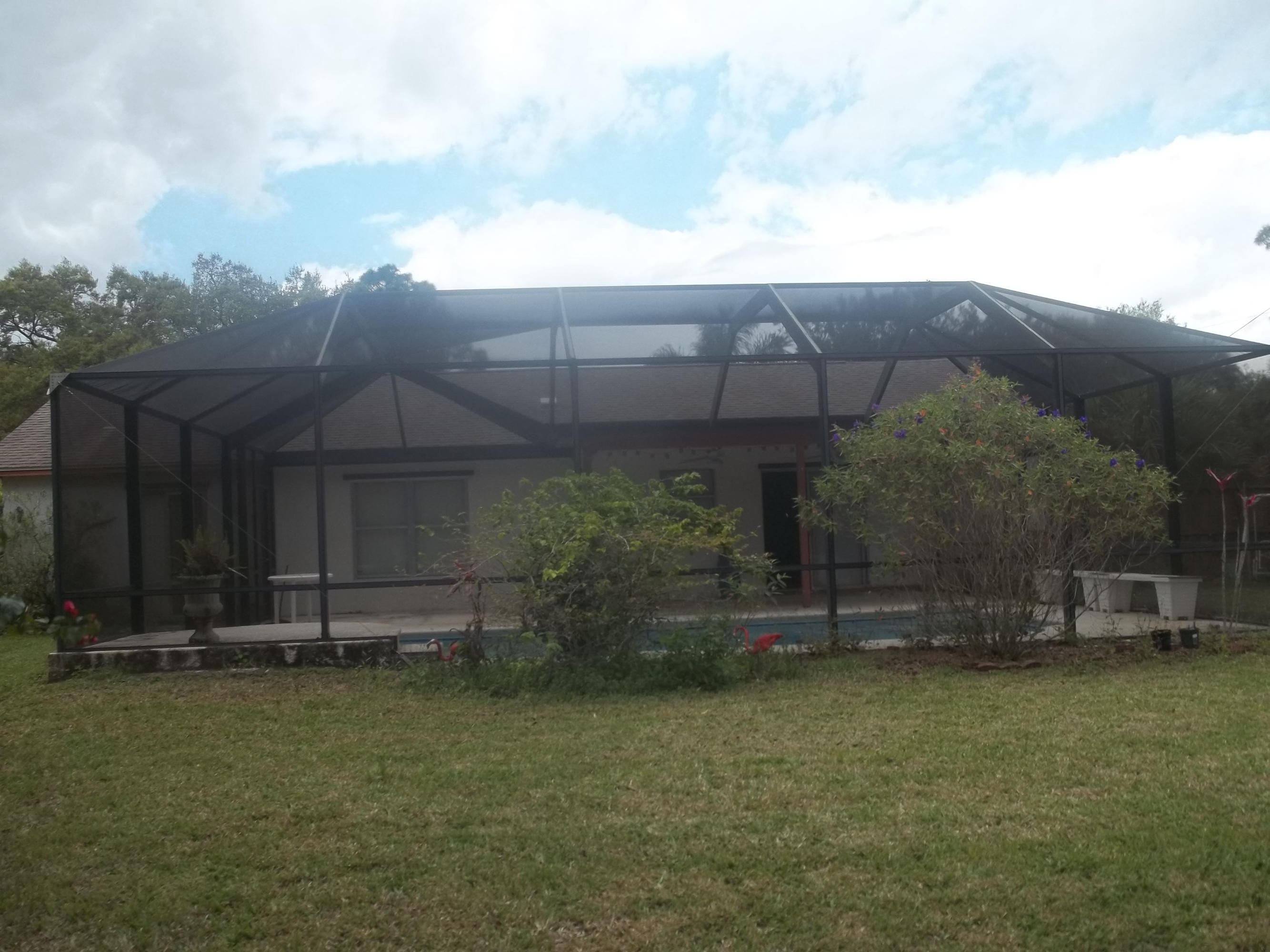 2201 Southwest Cree Road Port St. Lucie, FL 34953 - Photo 4 of 5 Backyard screen porch