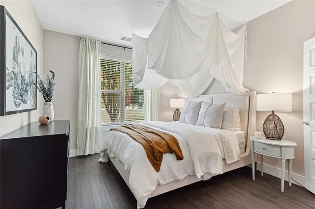 a bedroom with a bed and window