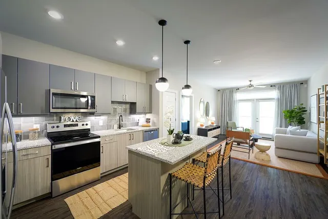 a kitchen with a table chairs stove and microwave