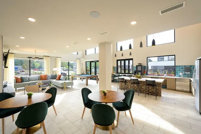 a living room with fireplace furniture and a large window