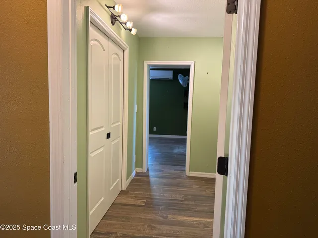 a view of a hallway with wooden floor