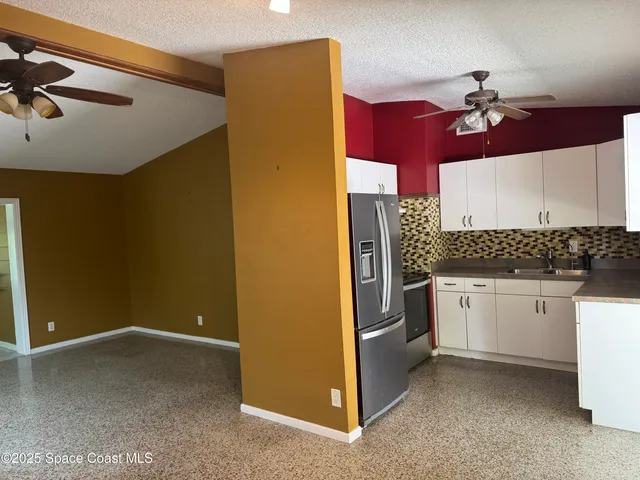 a kitchen that has a lot of cabinets and appliances