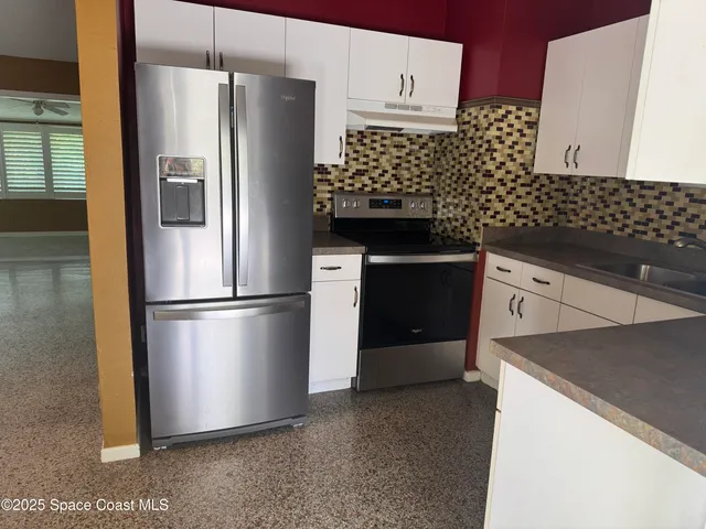 a kitchen with stainless steel appliances a refrigerator and a sink