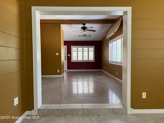 an empty room with windows and closet