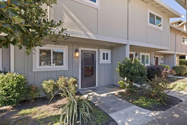 a hallway with cabinets and wooden floor