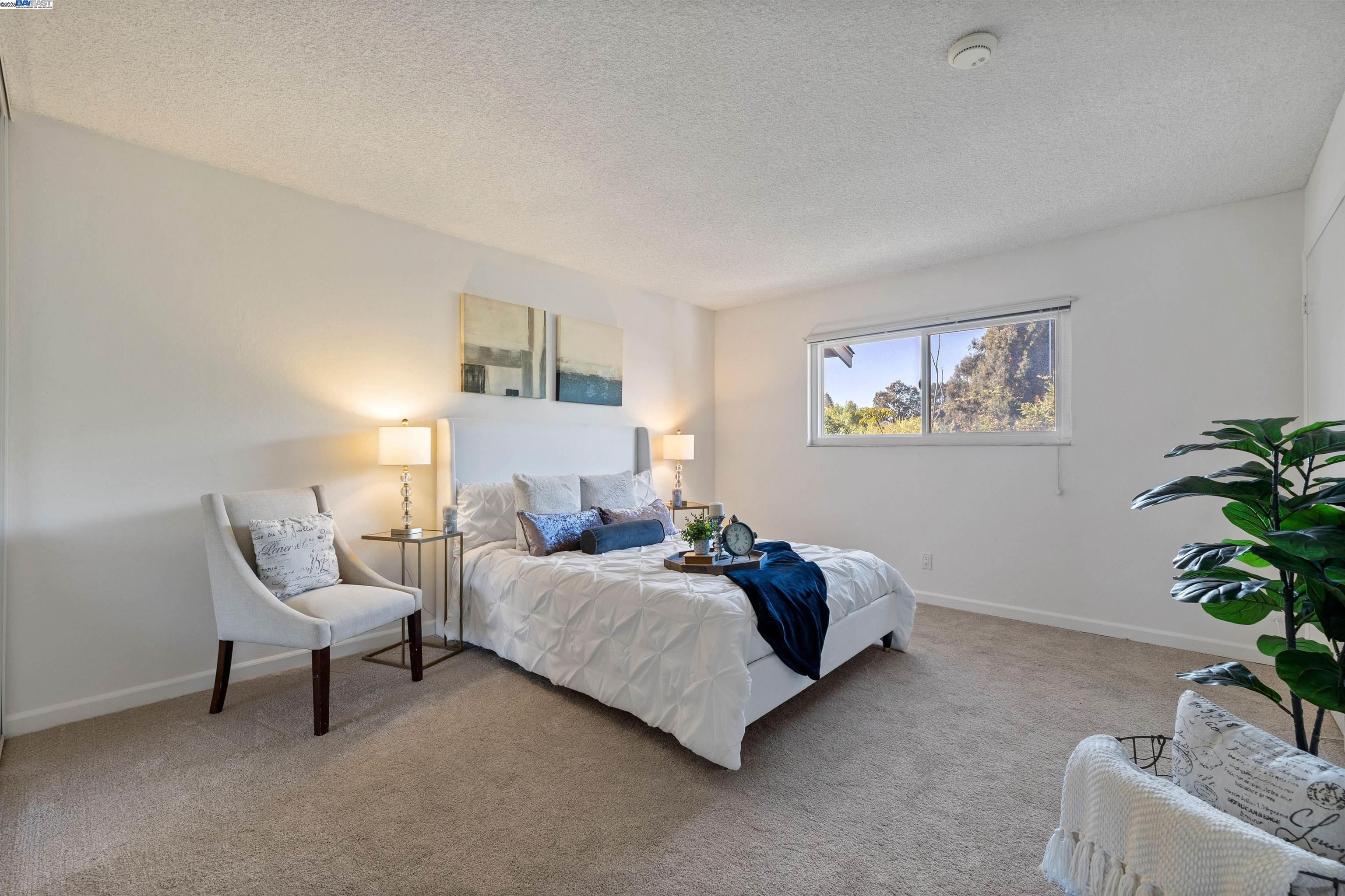 21053 Baker Road Castro Valley, CA 94546 - Photo 11 of 22 a bedroom with a bed and a potted plant