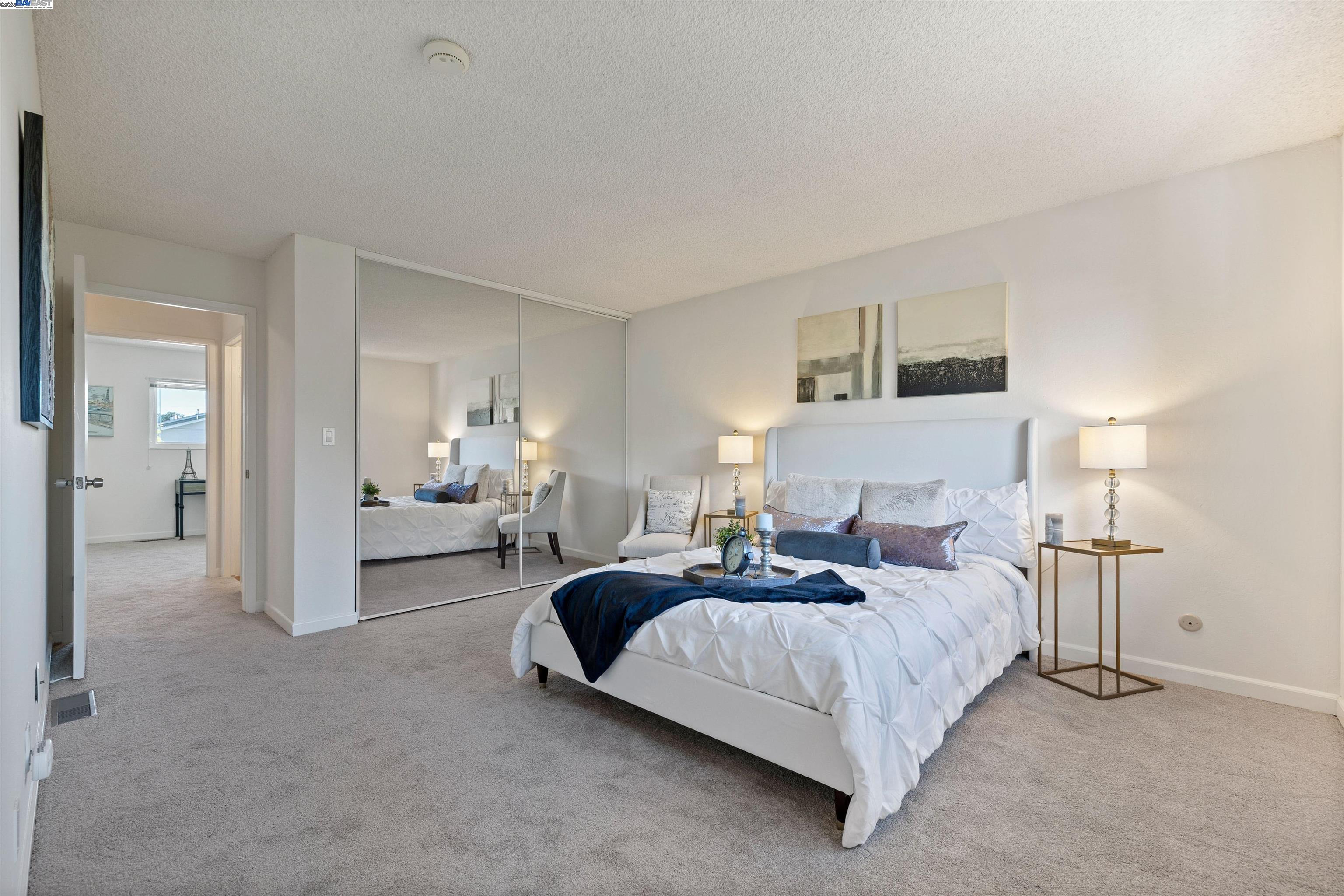 21053 Baker Road Castro Valley, CA 94546 - Photo 12 of 22 a bedroom with bed and white cabinets