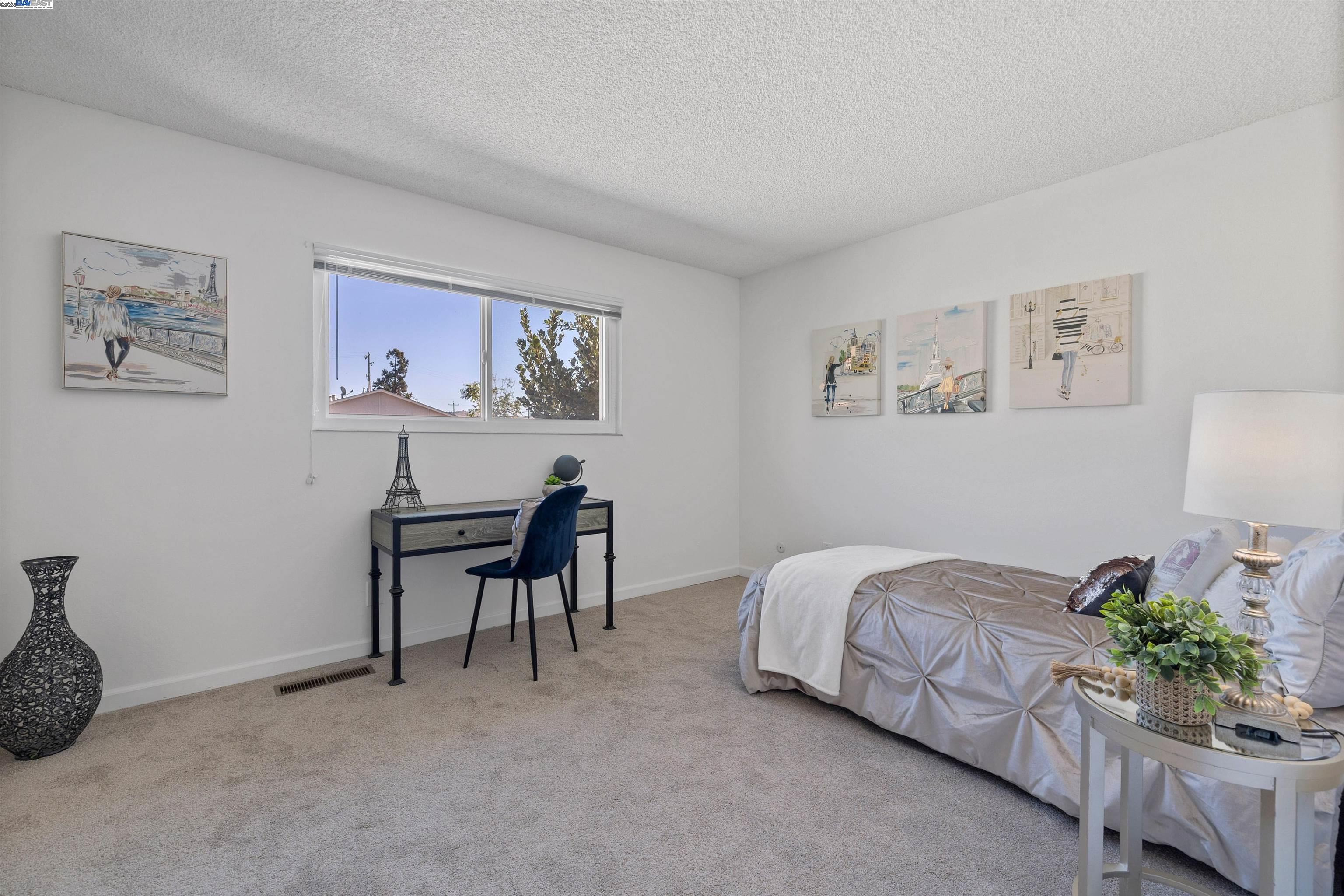 21053 Baker Road Castro Valley, CA 94546 - Photo 13 of 22 a bed room with a bed and a chair