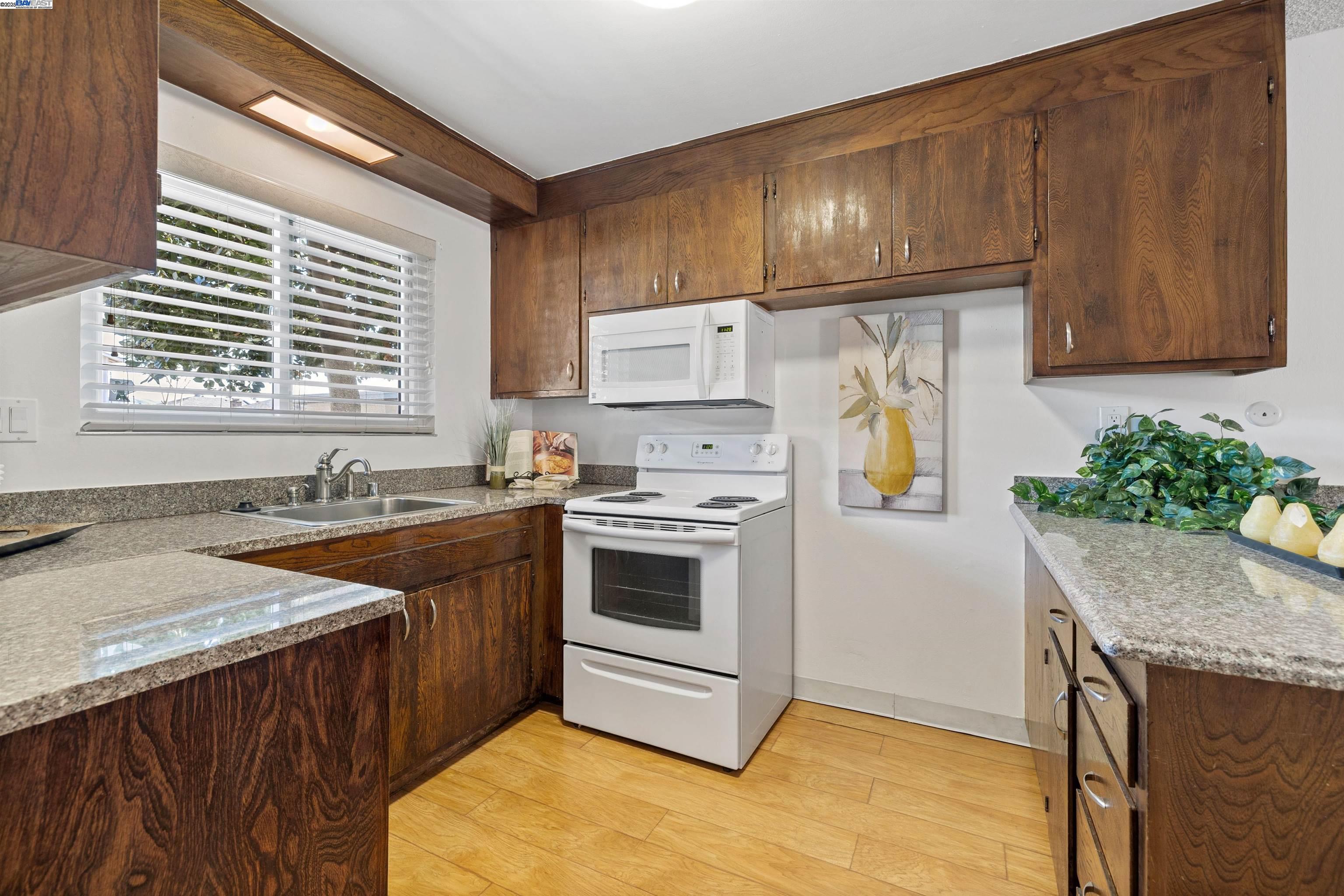 21053 Baker Road Castro Valley, CA 94546 - Photo 7 of 22 a kitchen with stainless steel appliances granite countertop a sink stove and refrigerator