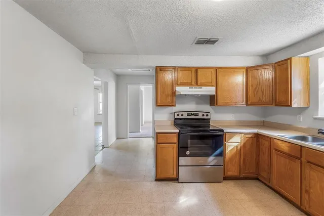 a kitchen with a stove and a sink
