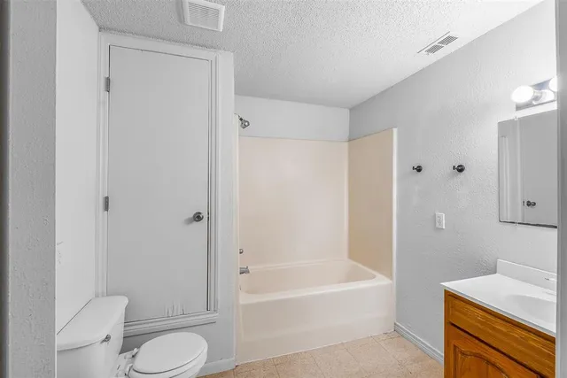 a bathroom with a toilet and a bathtub