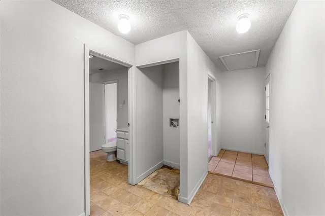 an empty room with closet and a bathroom view