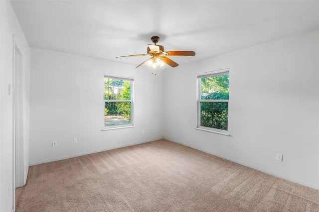 a view of a room with a window and a ceiling fan