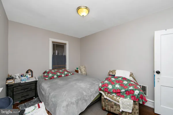 a bedroom with a bed and a dresser