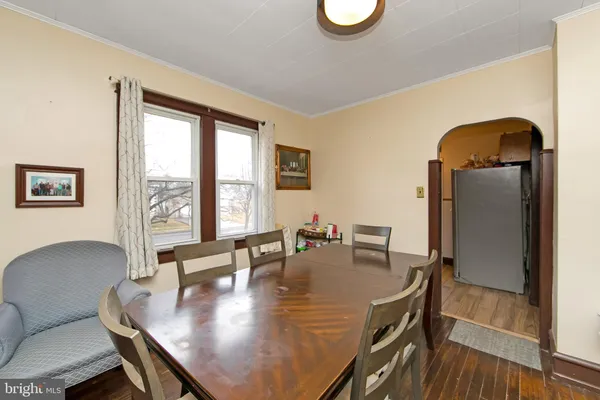 a dining room with furniture and wooden floor
