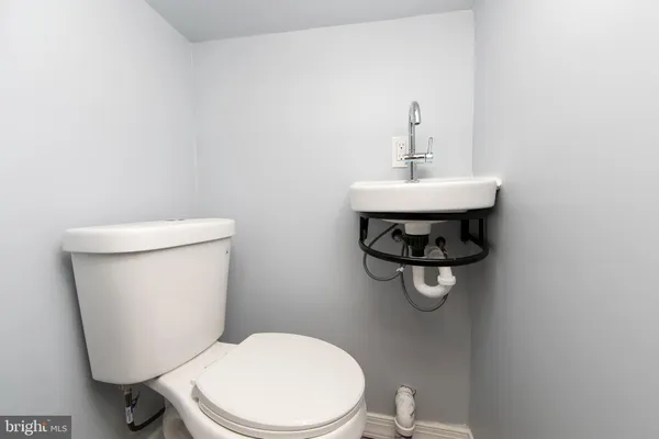 a white toilet sitting next to a bathroom sink