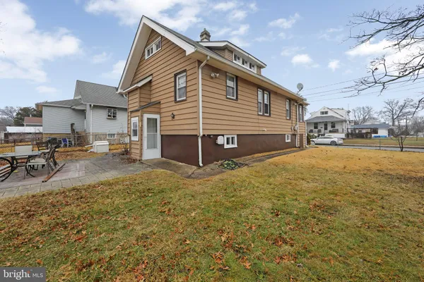 a view of a house with a yard and sitting area