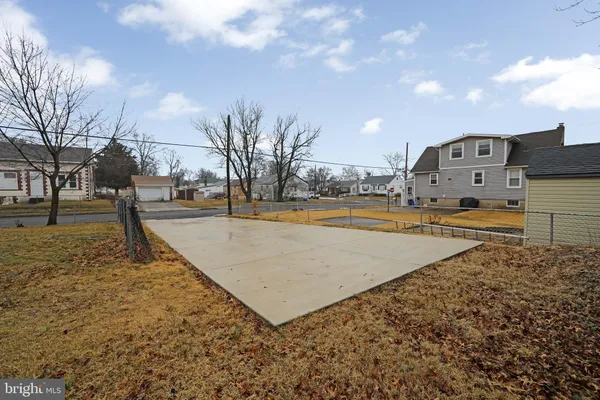 a view of a yard with snow on the road