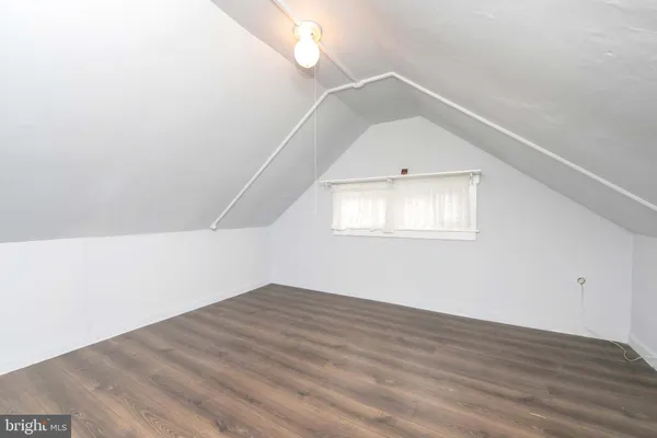 a view of a big room with wooden floor and windows