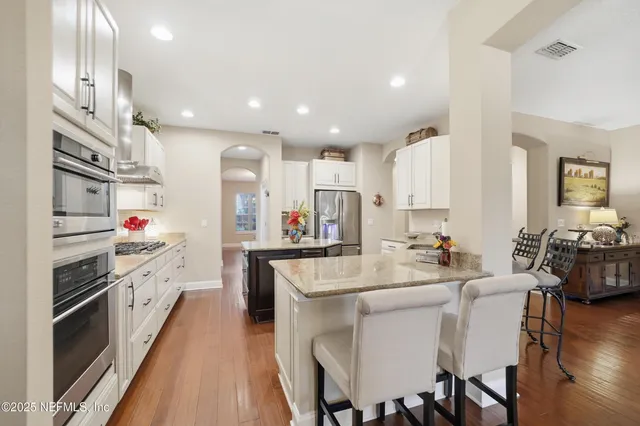 a large kitchen with lots of counter space and stainless steel appliances