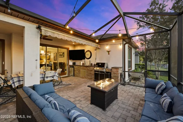 a living room with furniture a flat screen tv and a floor to ceiling window