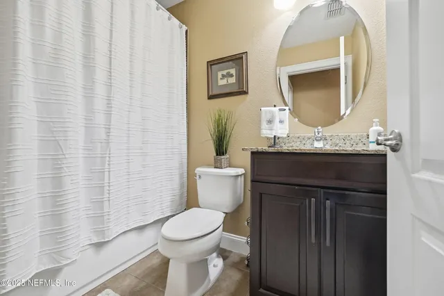 a bathroom with a toilet a sink and a mirror
