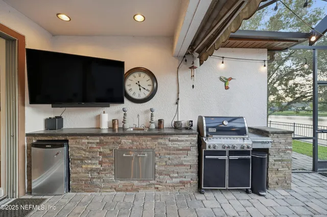 a kitchen with stainless steel appliances kitchen island granite countertop a stove and a microwave