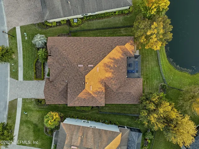 an aerial view of house with yard and ocean view