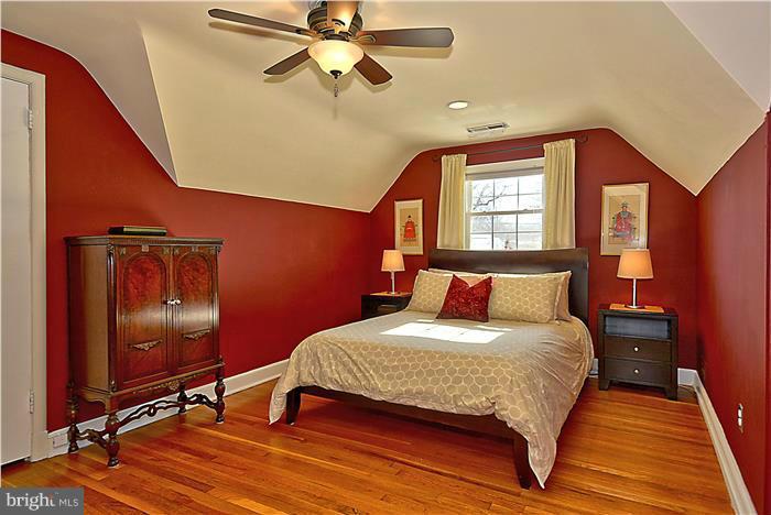 101 Hamilton Avenue Silver Spring, MD 20901 - Photo 14 of 29 a bedroom with a bed and wooden floor