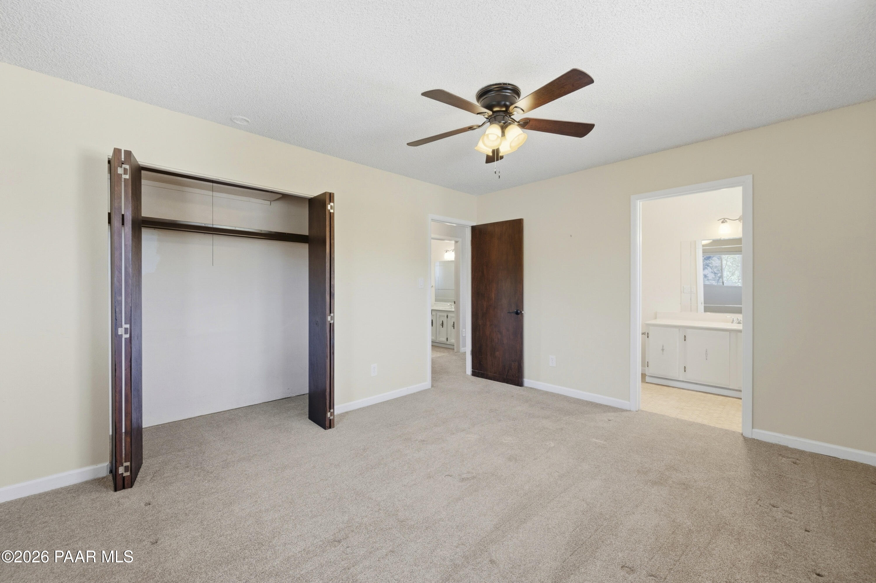 1775 Grandview Road Prescott, AZ 86305 - Photo 18 of 42 an empty room with closet and a chandelier fan