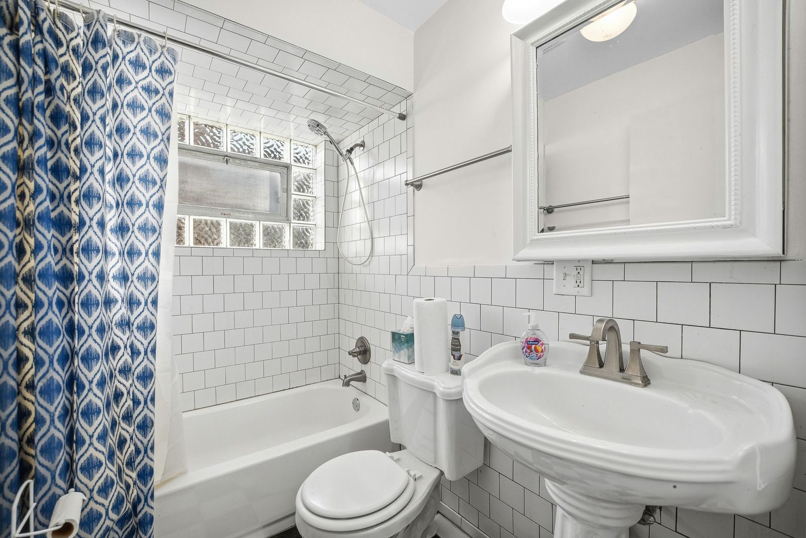 9209 South State Street Chicago, IL 60619 - Photo 4 of 20 a white bath tub sitting next to a white sink and a mirror
