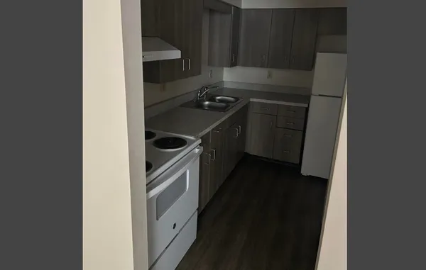 a kitchen with a stove and a refrigerator