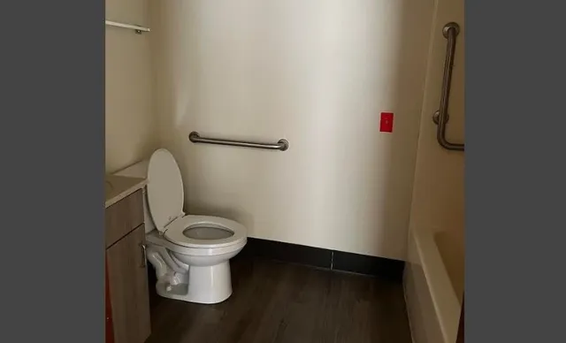 a white toilet sitting in a bathroom