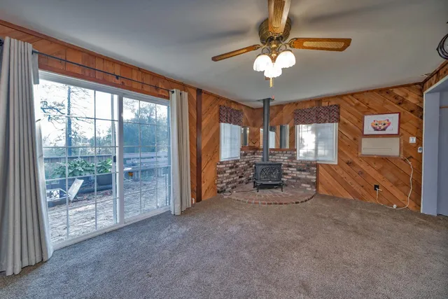 a living room with furniture and a floor to ceiling window
