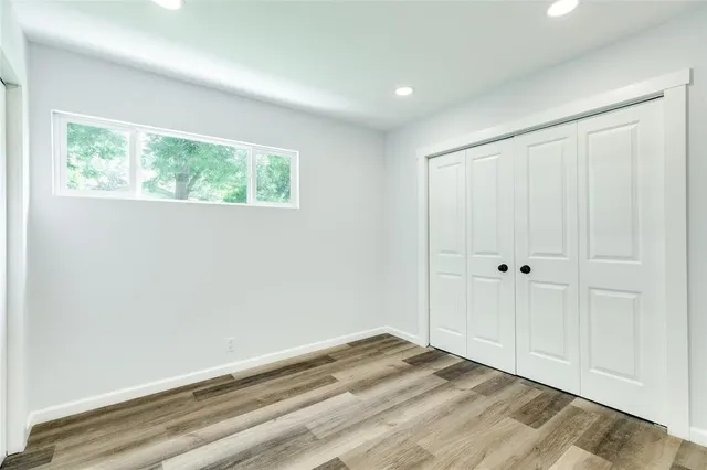 a bedroom with a bed couch and window