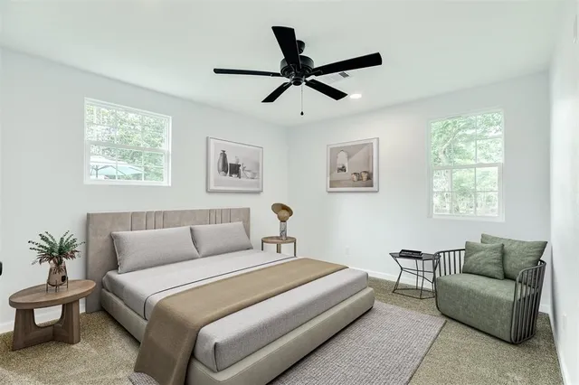 an empty room with a window and a ceiling fan