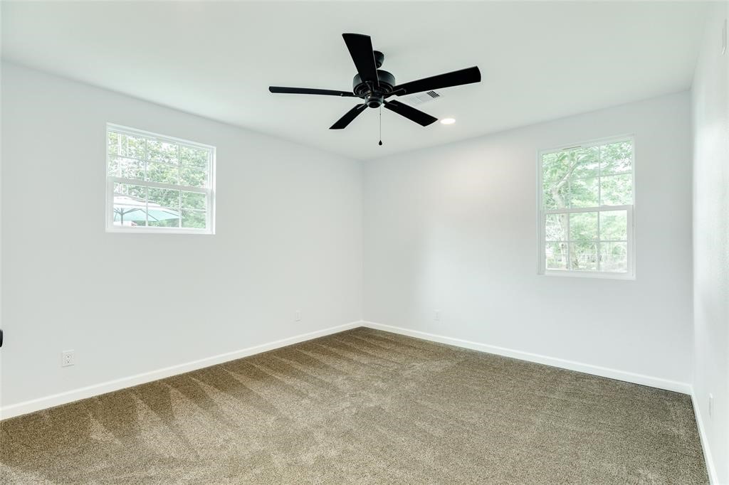 846 South Anderson Street Angleton, TX 77515 - Photo 18 of 29 an empty room with a window and a ceiling fan