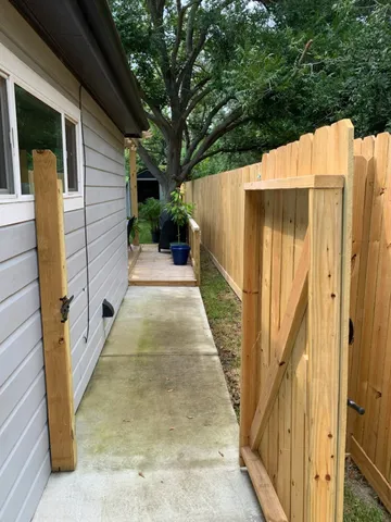 a view of a back yard with a wooden fence