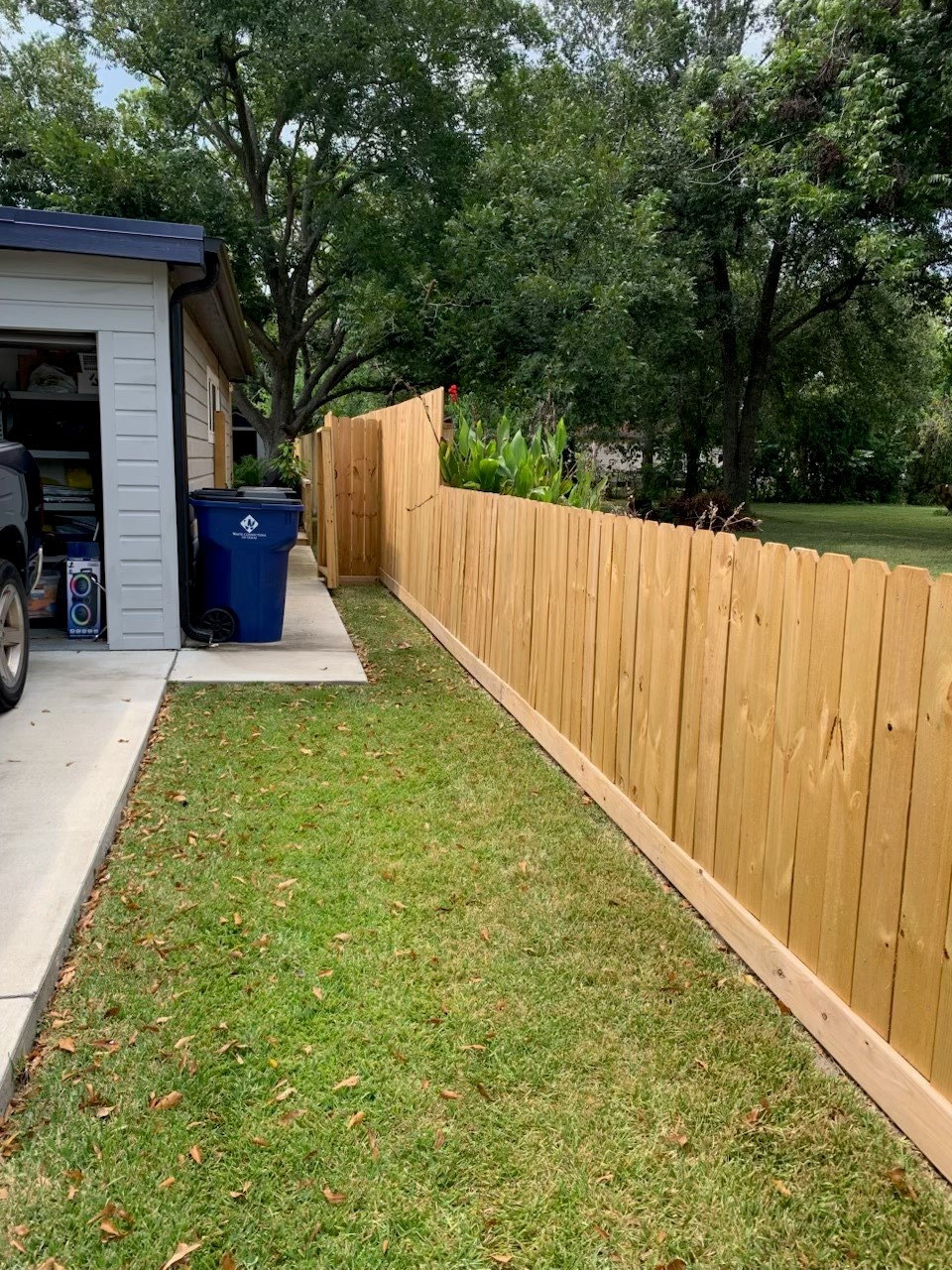 846 South Anderson Street Angleton, TX 77515 - Photo 26 of 29 a view of a back yard with a wooden fence