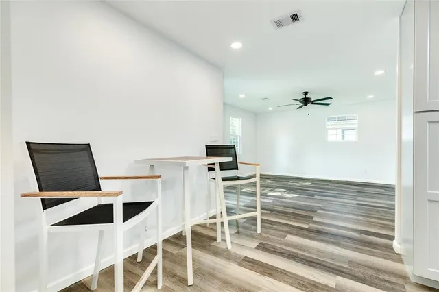 a kitchen with granite countertop cabinets and chairs
