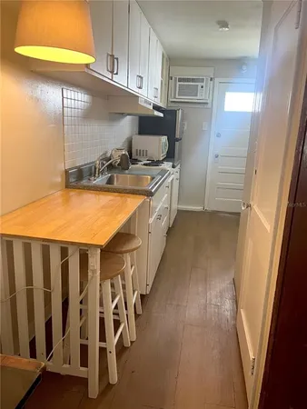 a bed sitting in a bedroom next to a lamp