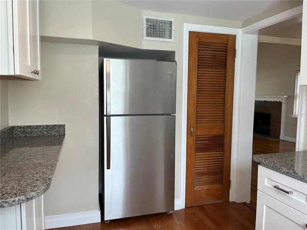 a kitchen with stainless steel appliances granite countertop a refrigerator and a sink