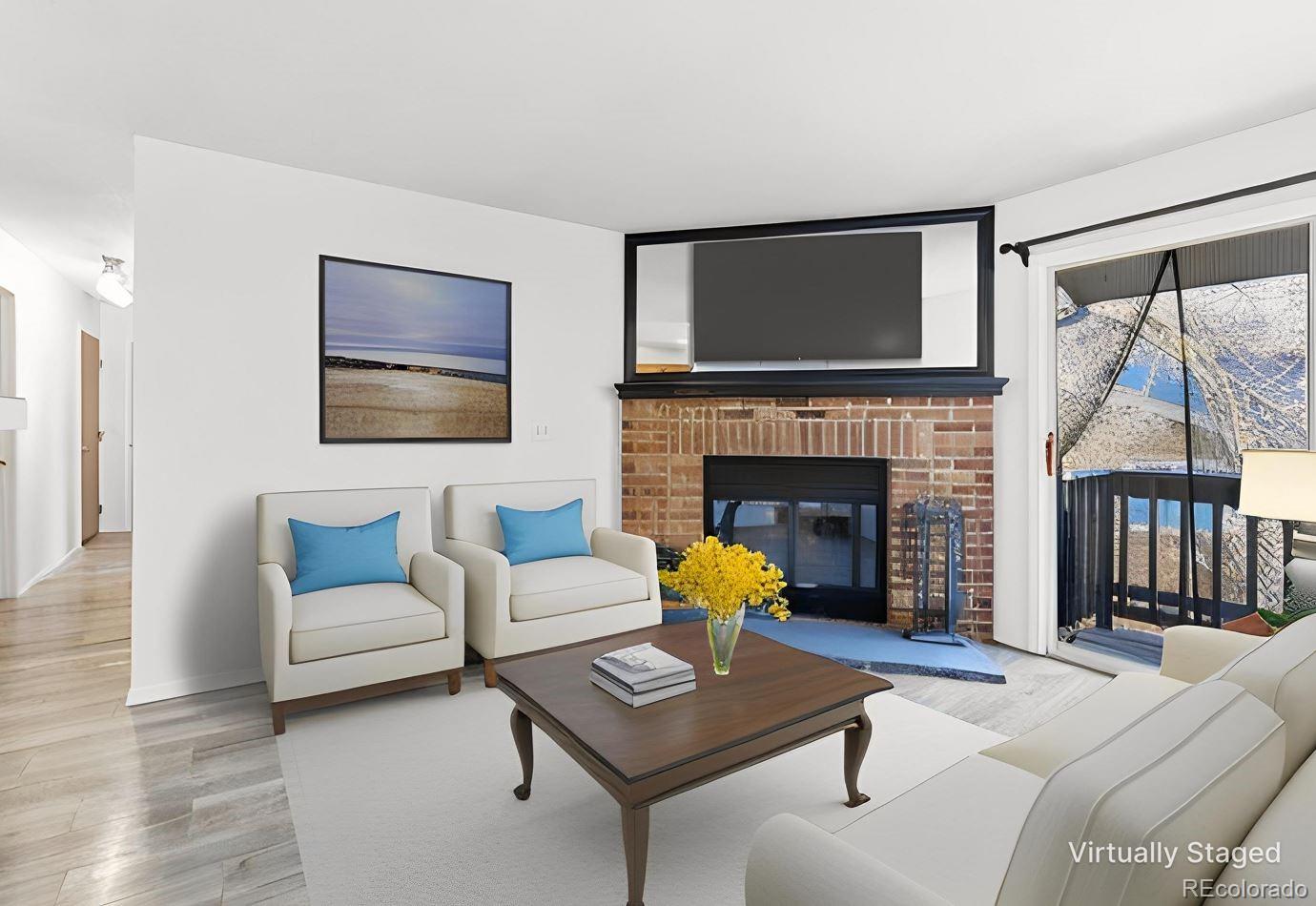 a living room with furniture a flat screen tv and a fireplace