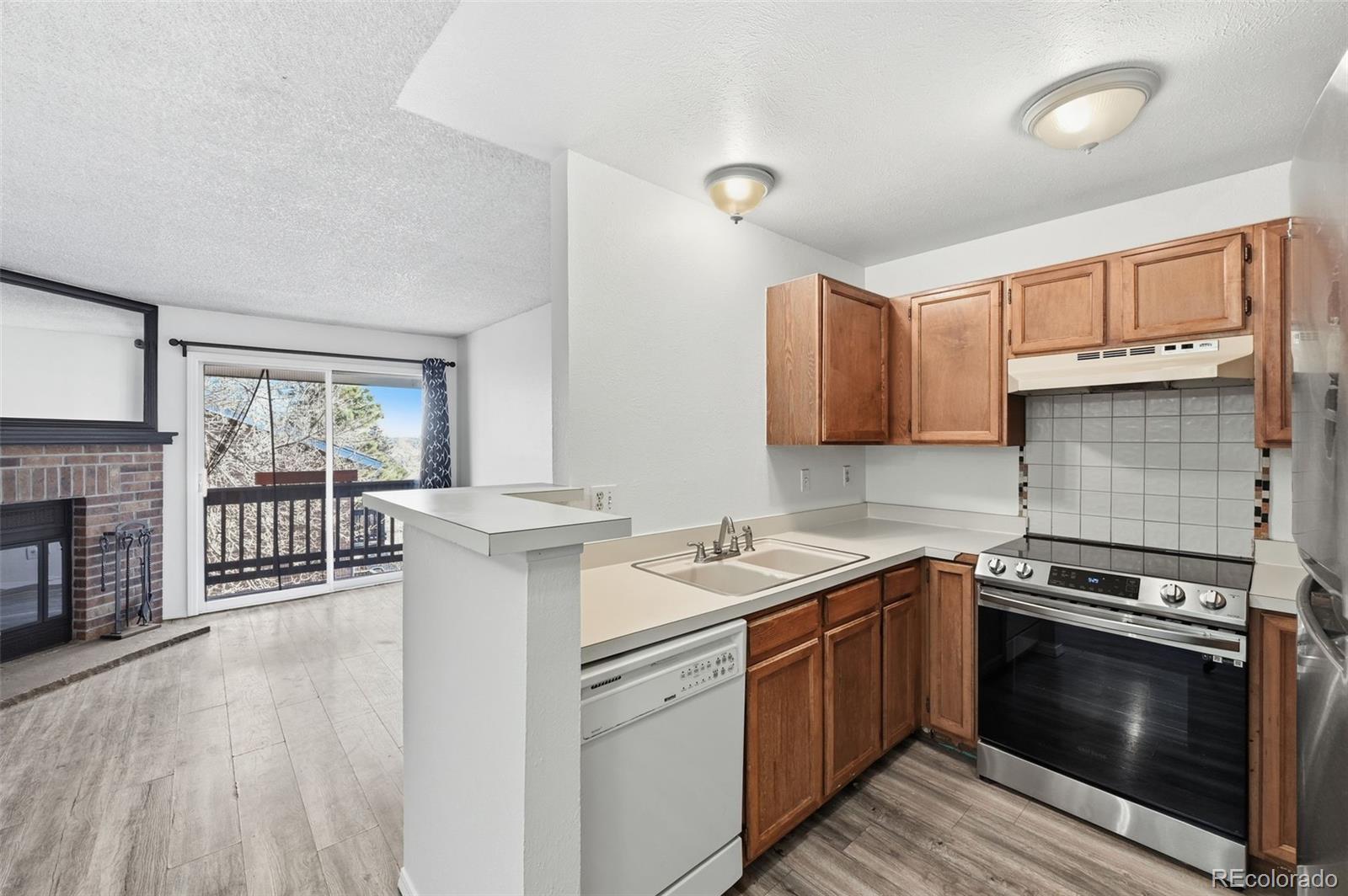 7883 Allison Way, Unit 302 Arvada, CO 80005 - Photo 15 of 29 a kitchen with a stove oven and sink