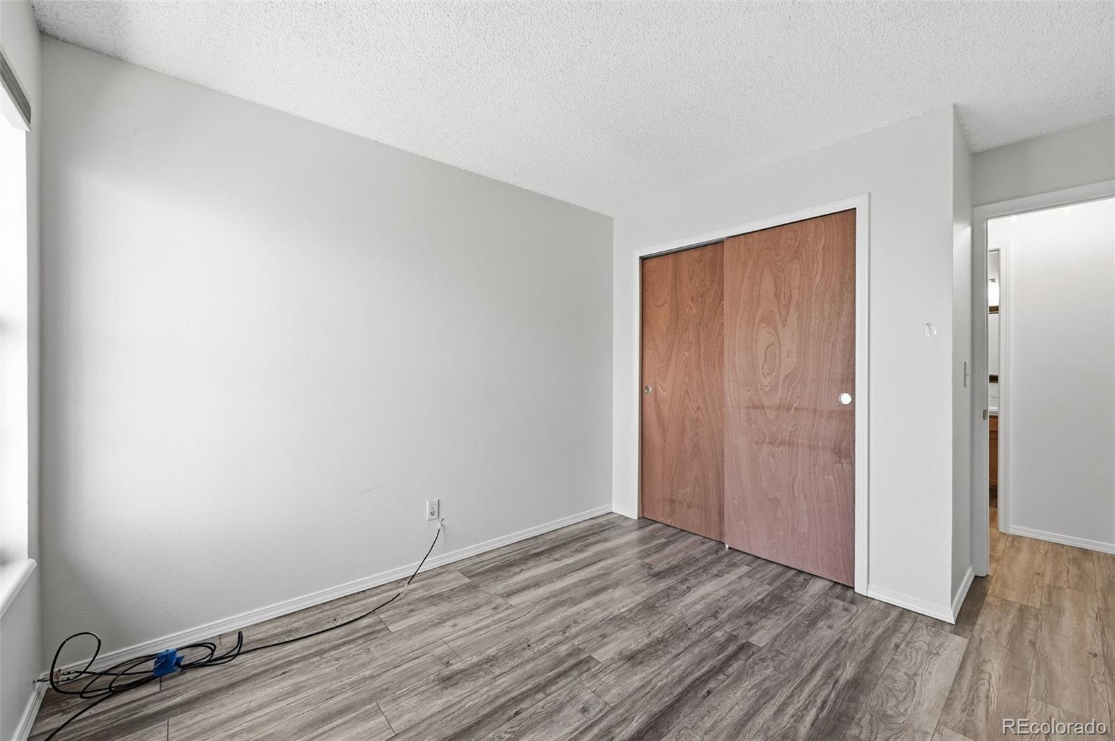 7883 Allison Way, Unit 302 Arvada, CO 80005 - Photo 20 of 29 a view of room with wooden floor