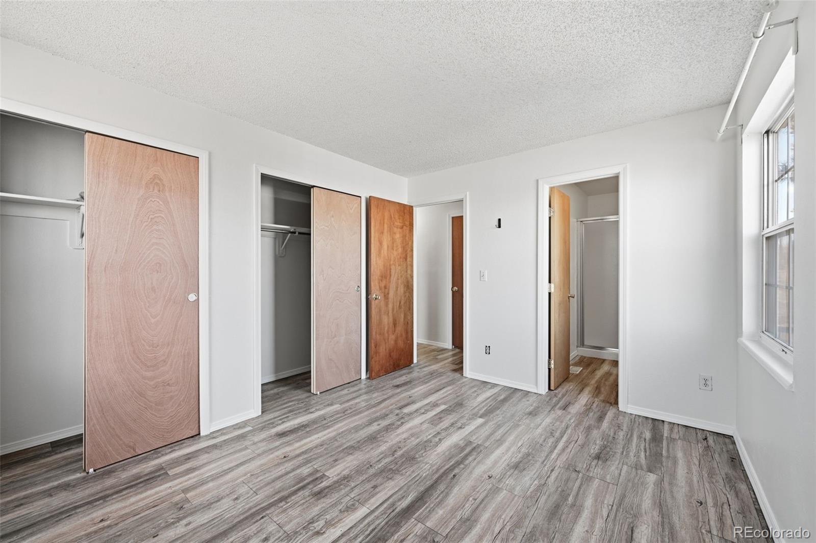 7883 Allison Way, Unit 302 Arvada, CO 80005 - Photo 26 of 29 an empty room with closet and wooden floor
