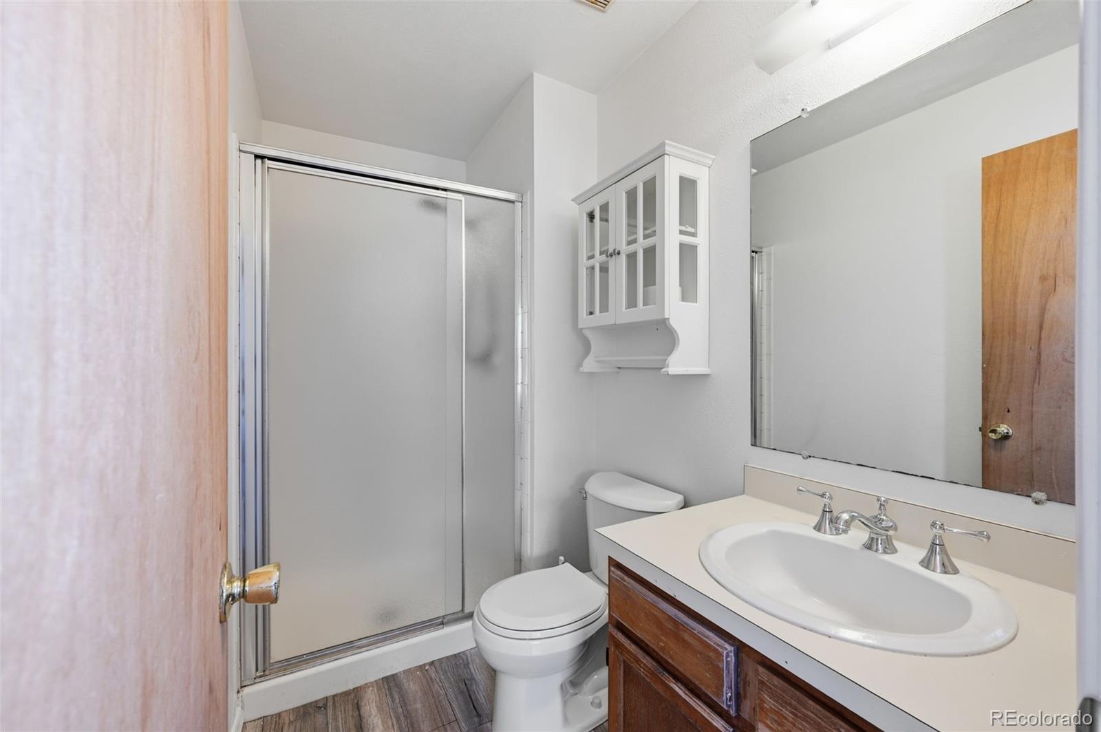 7883 Allison Way, Unit 302 Arvada, CO 80005 - Photo 27 of 29 a bathroom with a sink toilet and shower